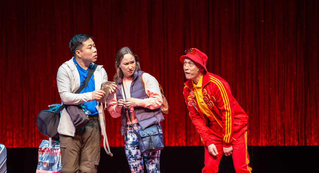 Three people standing on a stage