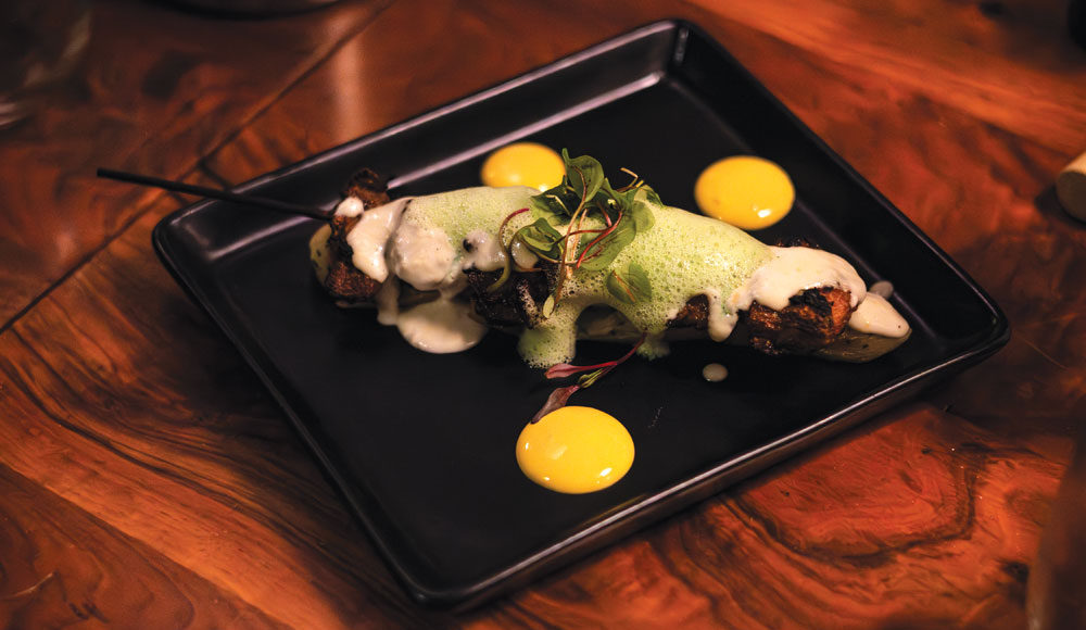 Decoratively presented plate of food on a wooden table