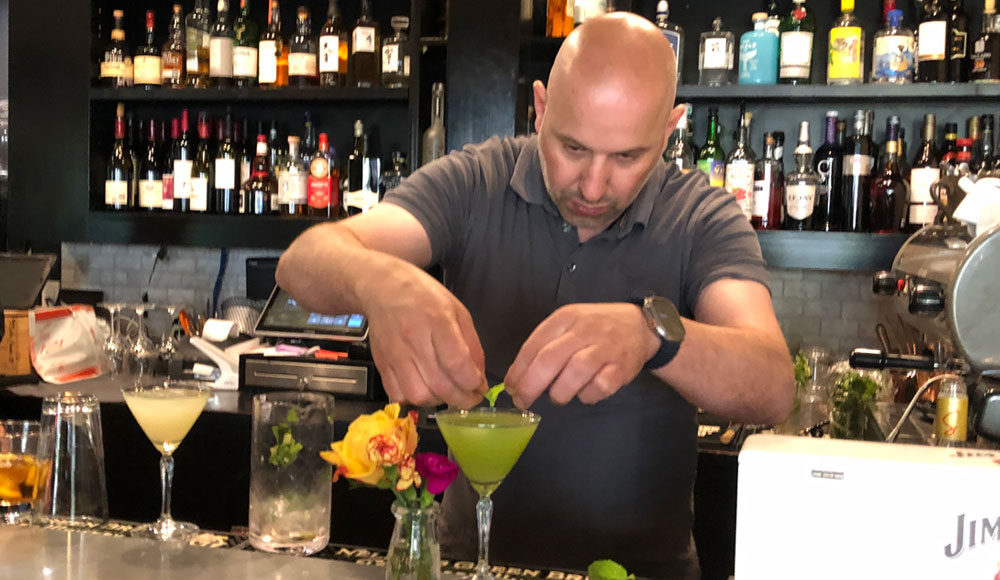 Man mixing a drink at a bar