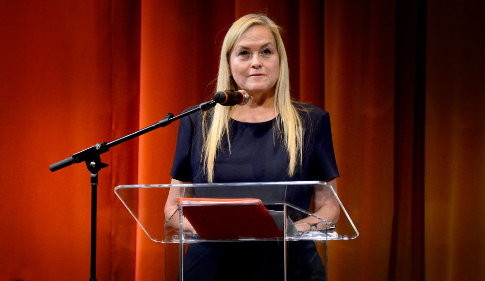 Photo of woman in front of a lectern