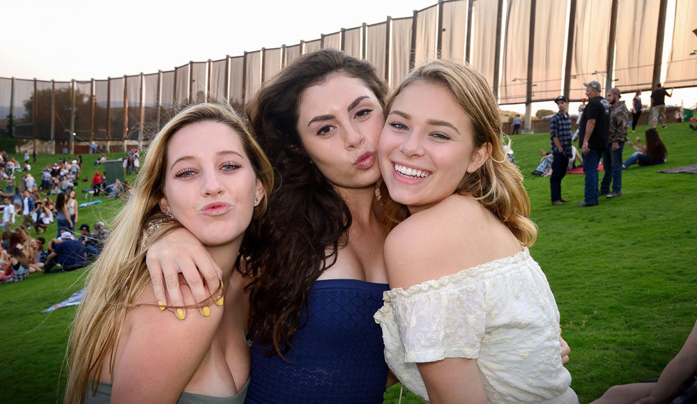 Three concert-goers outdoors posing for a picture