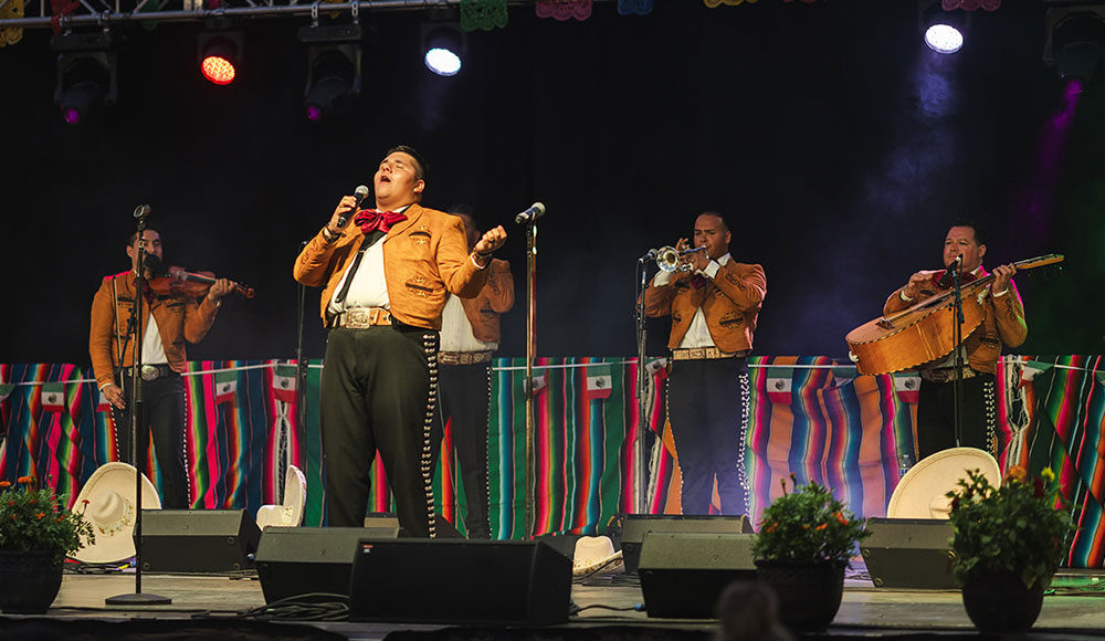 Mariachi singer on stage with other musicians