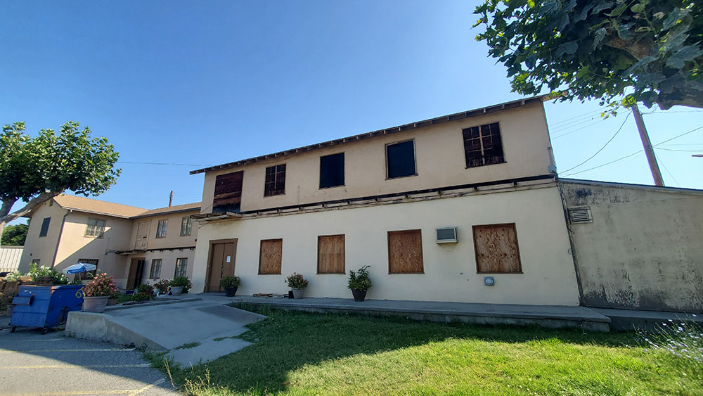 Dilapidated building with boarded-up windows