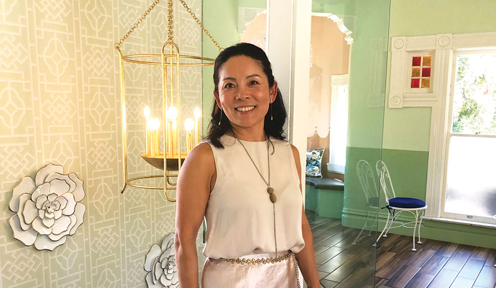 Woman standing in a sun-filled room