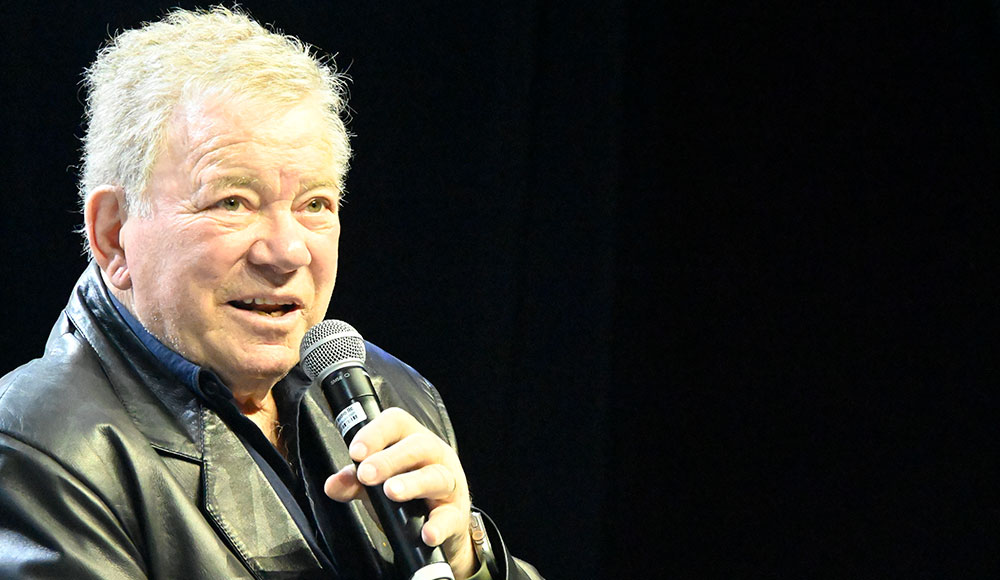 William Shatner speaking into a microphone