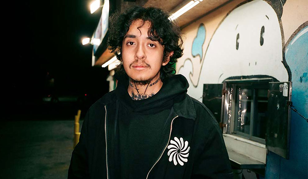 Man looking at the camera on the street at night