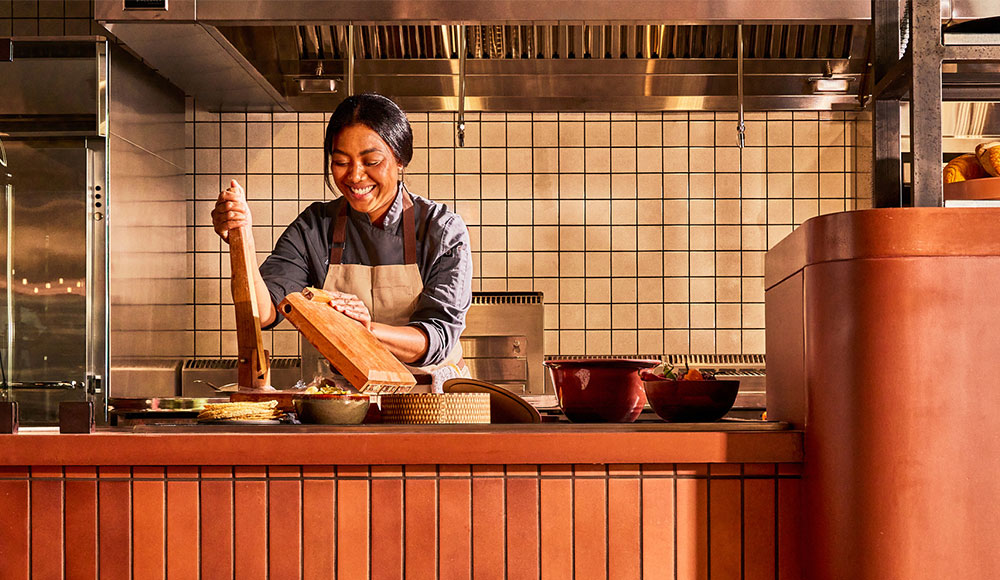 Woman cooking in an open kitchen