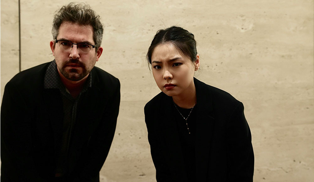 Two people leaning toward the camera