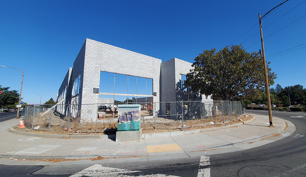 Building under construction in an empty lot on a corner