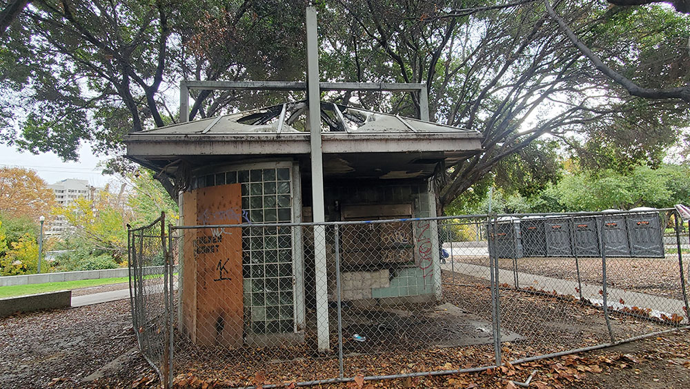 Rundown building surrounded by chainlink fence