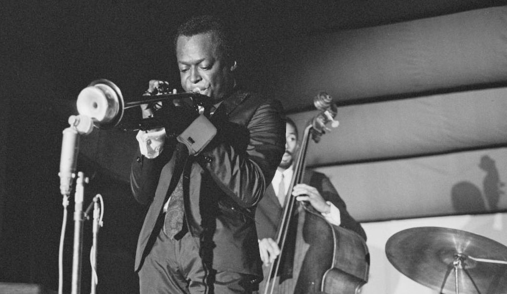 Man playing trumpet on a stage; black-and-white archival photo