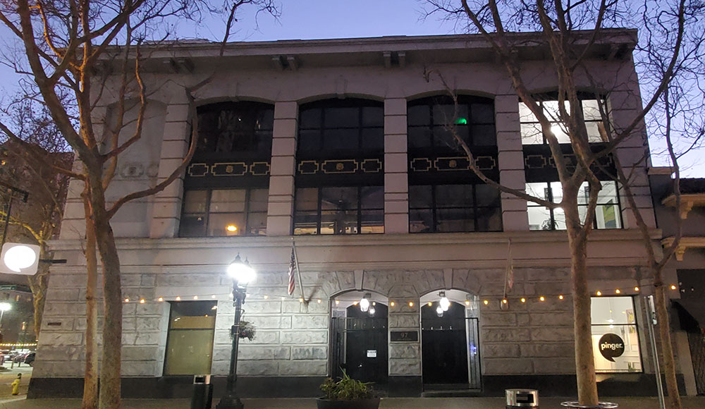 Photo of a building on a ciy street at dusk