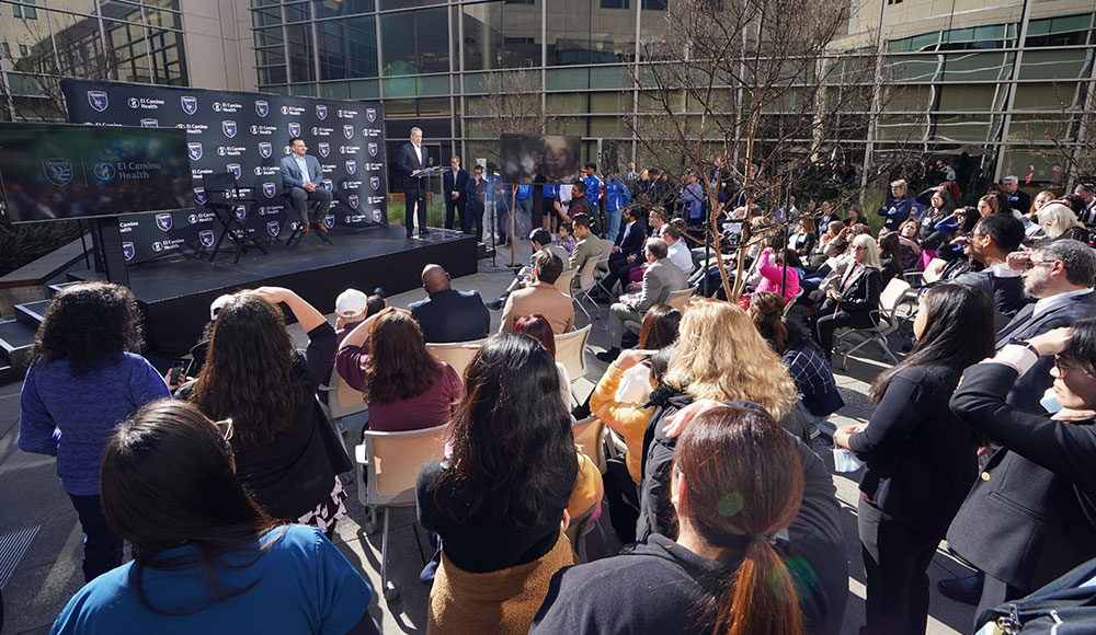 Crowd of reporters at an outdoor press conference