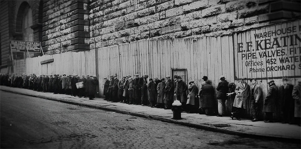 Archival black-and-white photo of men lined up on a street