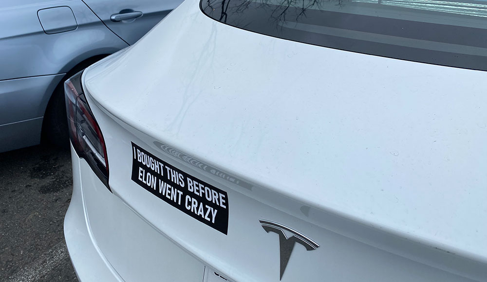 Tesla with an anti-Musk bumper sticker
