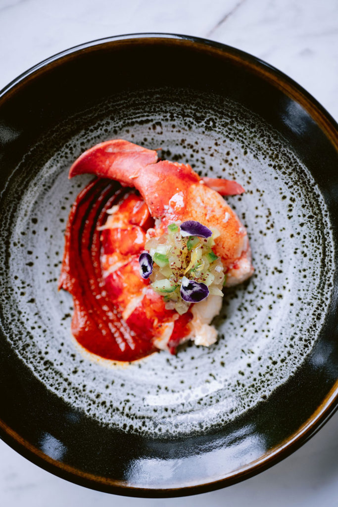 Cooked lobster dish on a heavy ceramic plate