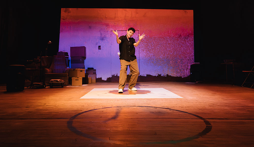 Woman on a stage alone with dramatic lighting