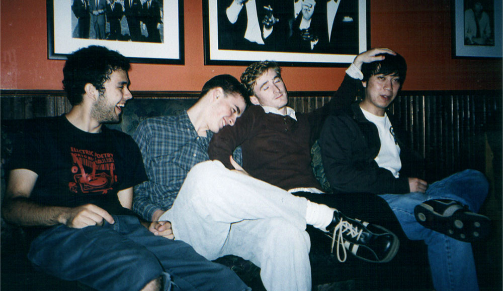 Four people sitting on a couch