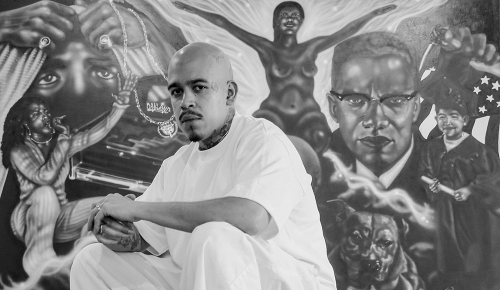 Man sitting in front of a large painting