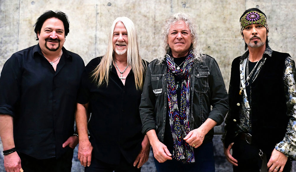 Four men standing in a row