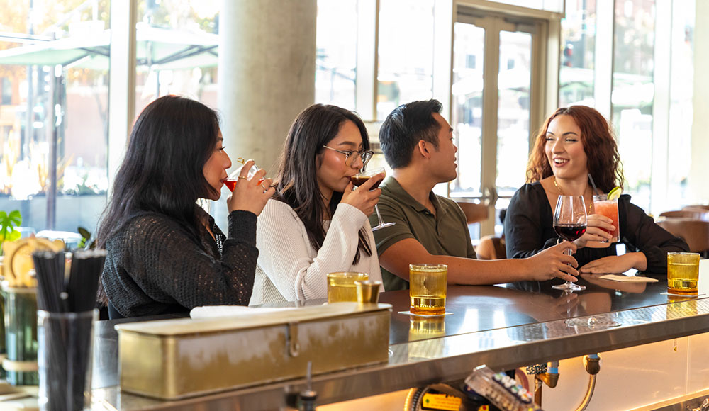 People sitting at a bar during daylight