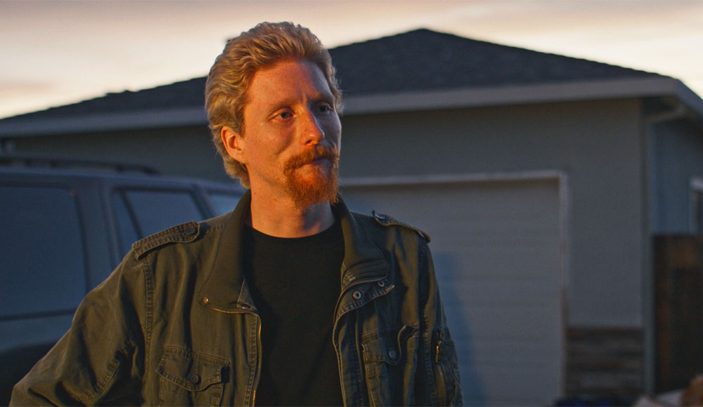 Man standing outside in front of a house