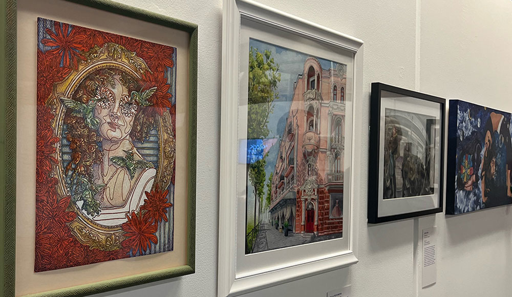 Row of paintings on a white wall
