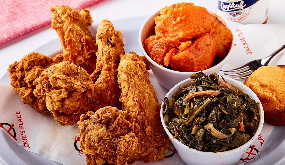 Chicken wings and two side dishes in little bowls