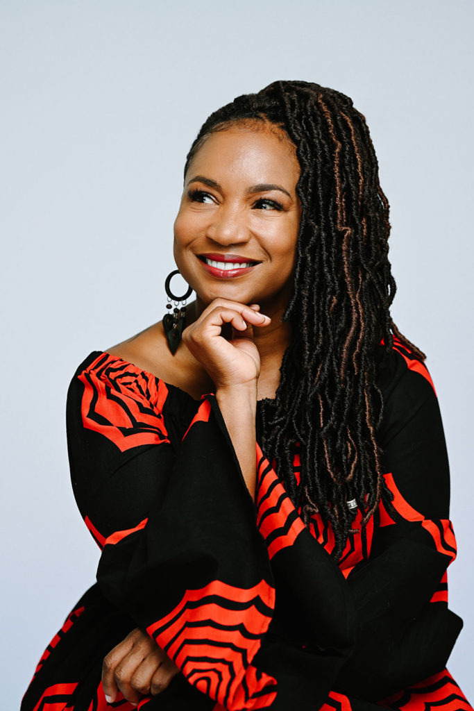 Photo of smiling woman in a black-and-red dress