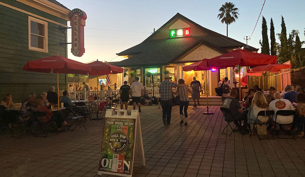 Bar in an old wooden structure with lights twinkling at dusk