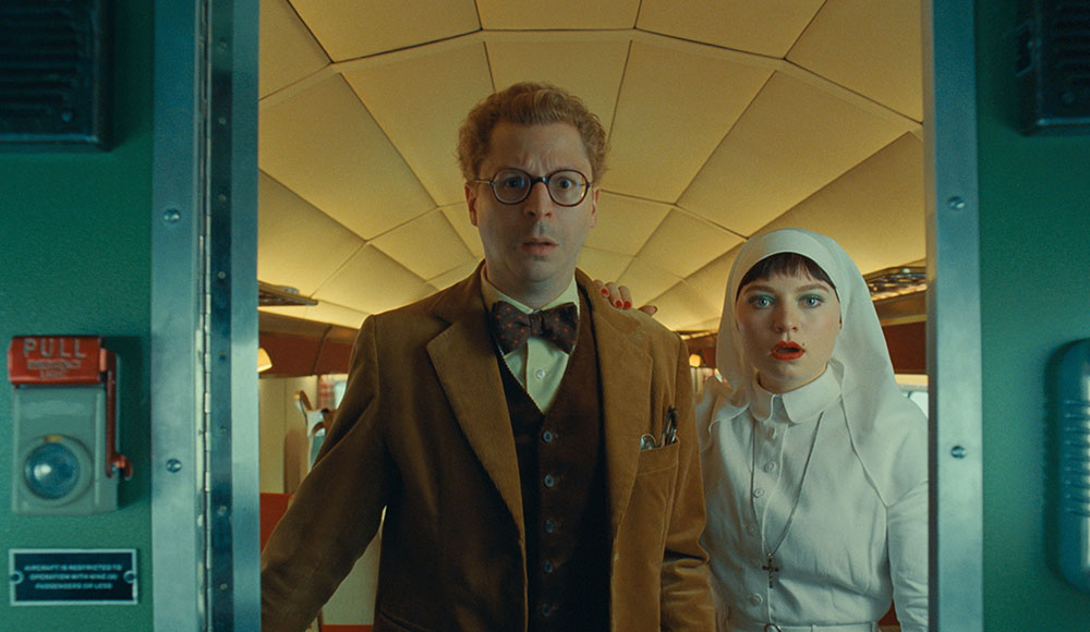 Two people framed in an opening in an aircraft