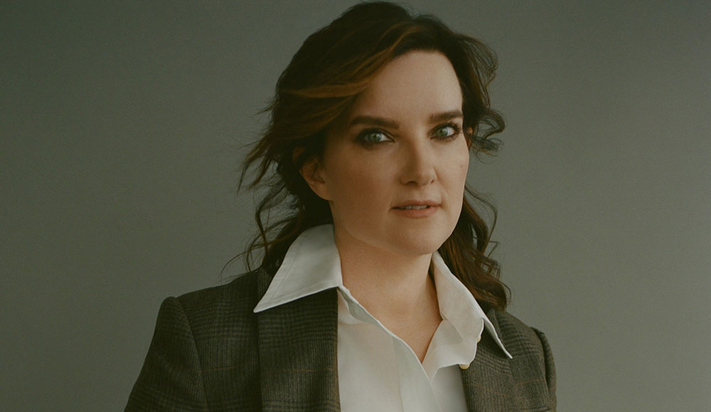Woman posing for a portrait wearing a jacket and a white shirt