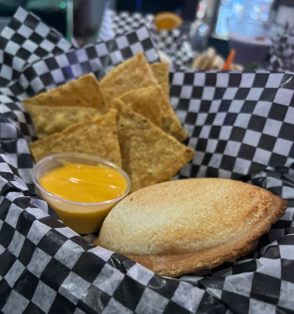 Pastry with a side of mustard and chips