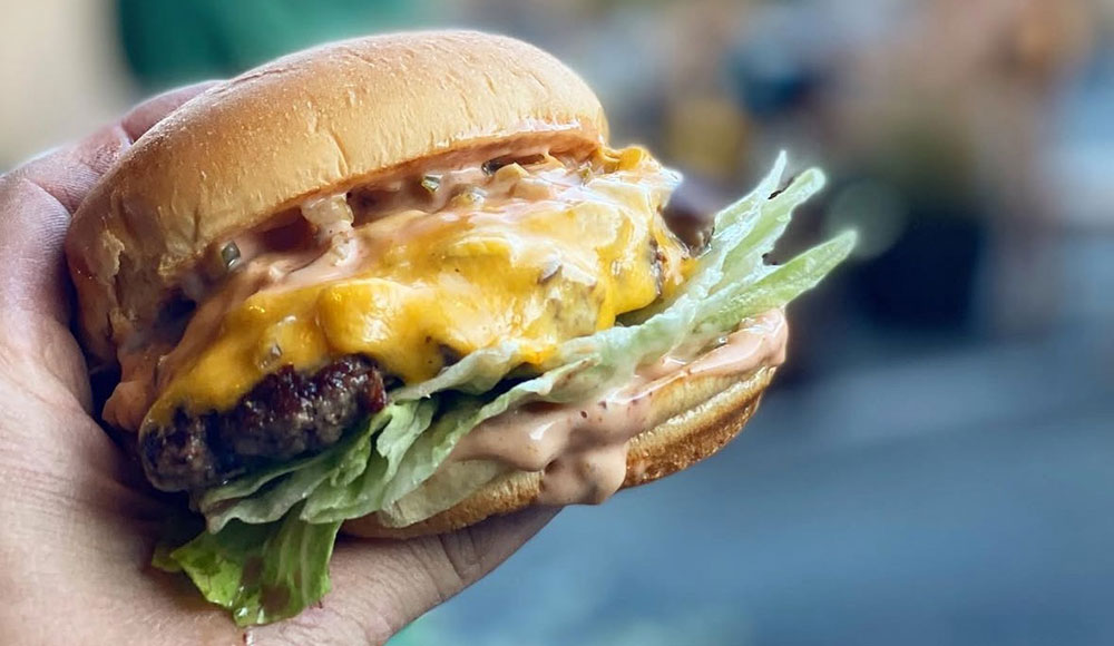 Burger held in one hand