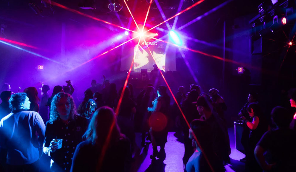 People in a nightclub with dramatic lighting