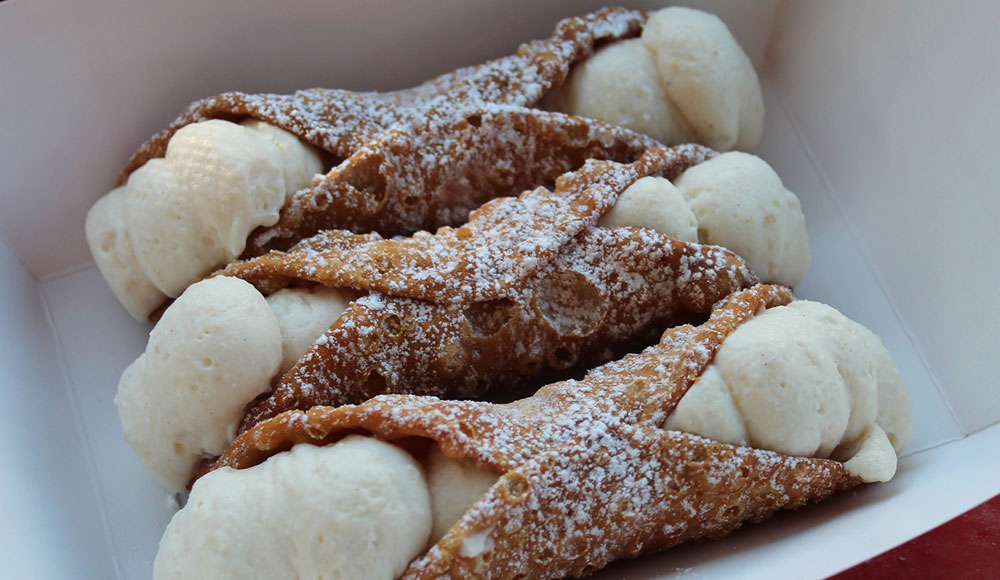 Three cannoli on a plate