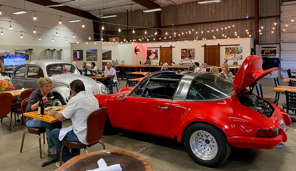 Room with cars and restaurant tables