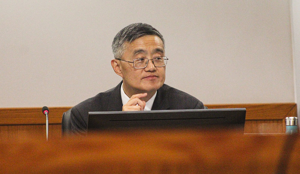 Man sitting behind a desk at a meeting