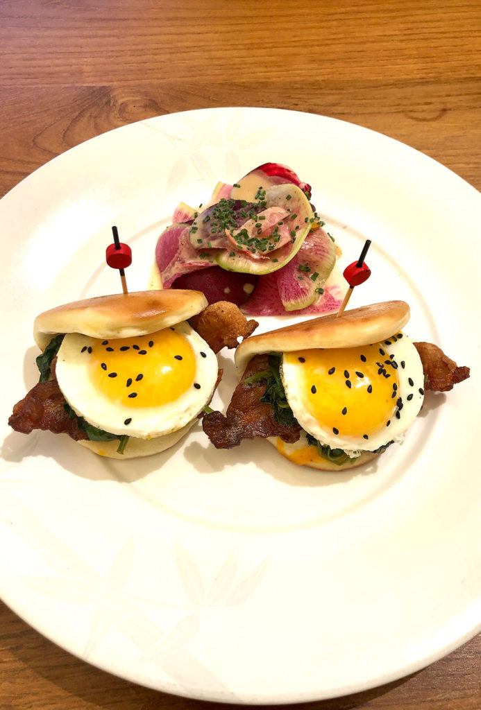 Eggs on a bao bun with salad garnish