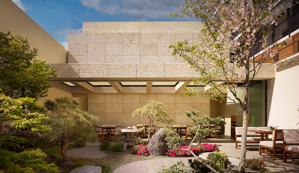 Courtyard of restaurant filled with plants and flowers