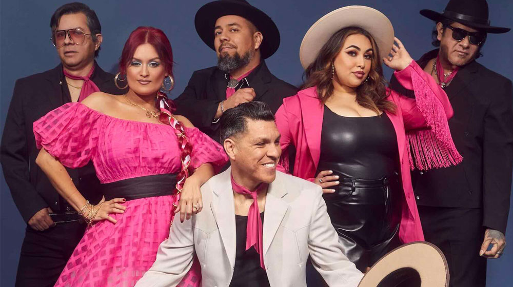 Band photo of six musicians in colorful attire