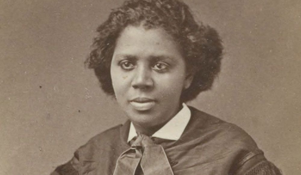 Sepiatone photo of a woman dressed in garb from the 19th century