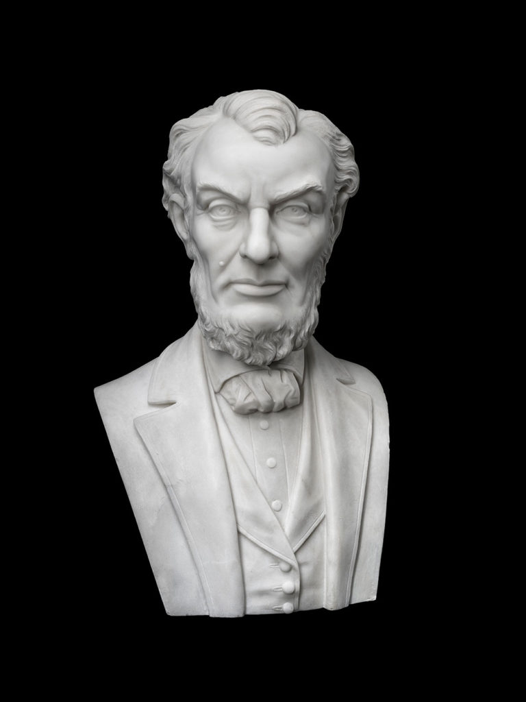 White marble bust of Abraham Lincoln on a solid black background