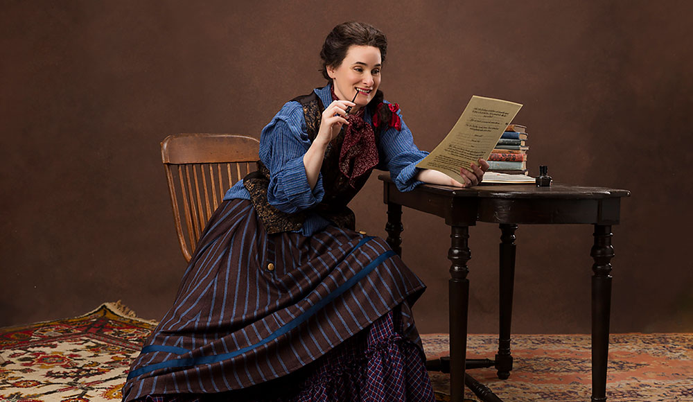 Woman on stage dressed in 19th-century clothing