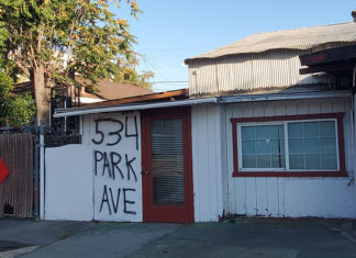 Building that looks empty with its address written on the door.