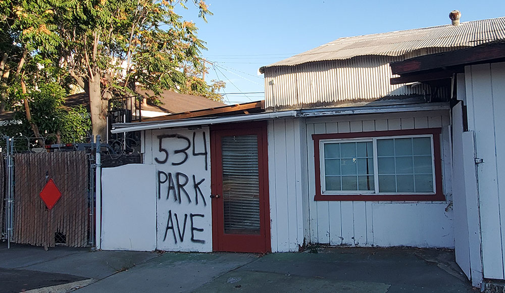Building that looks empty with its address written on the door.
