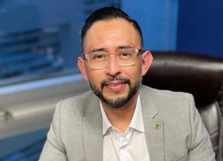Man in a suit sitting at a desk