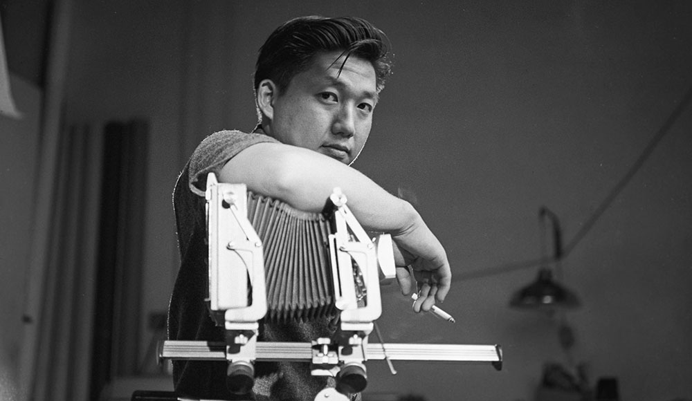 Man leaning on a vintage camera