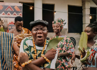Photo of a man holding an object and making a funny face