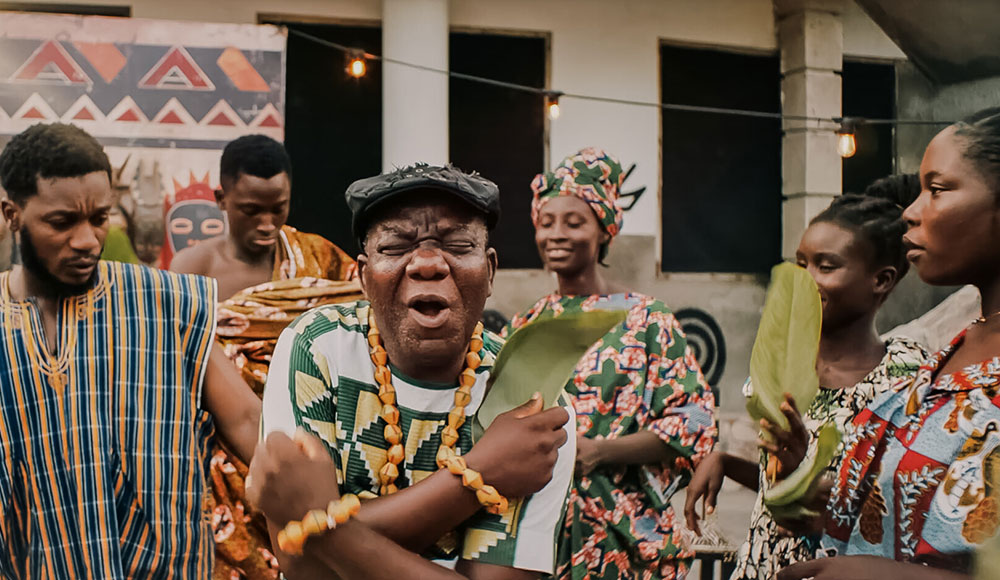 Photo of a man holding an object and making a funny face